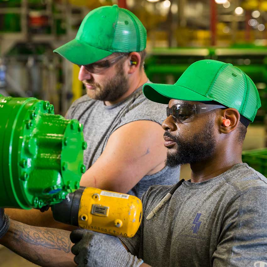 two individuals working with machines